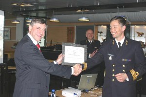 Jaap van der Lelie (l), acting chapter president, hands 
a certificate of appreciation to Cdre. Toin Vergroessen, RNLN, 
for his presentation on the Defense Helicopter Command.

